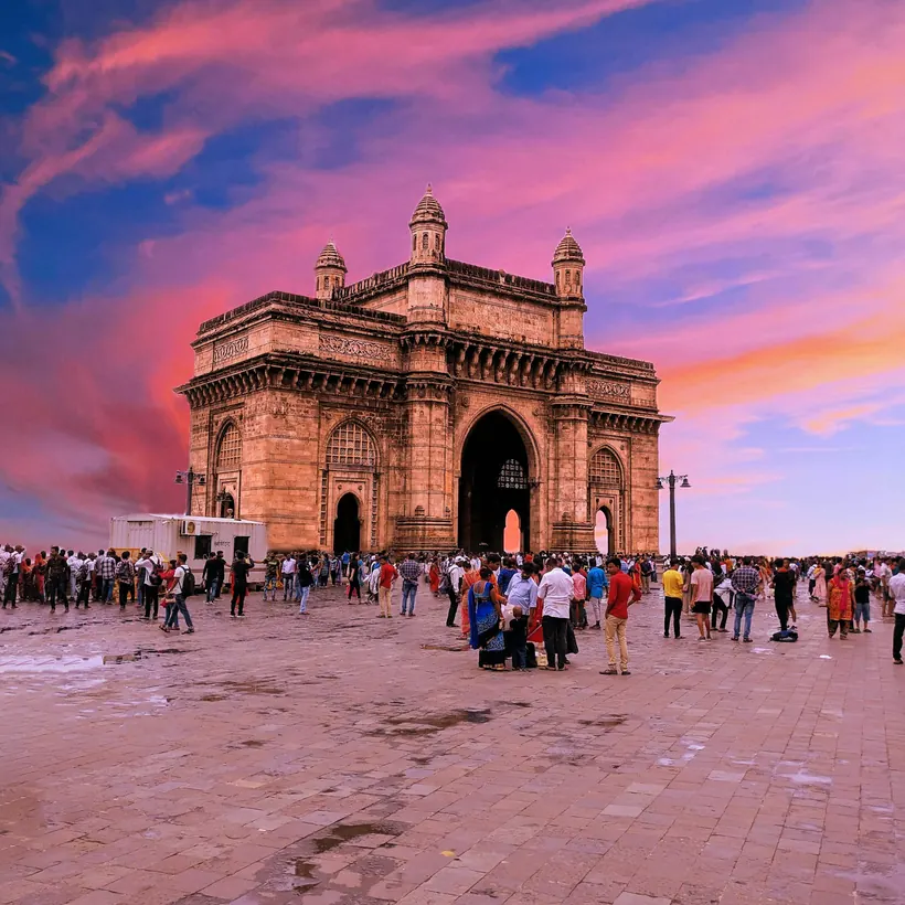 The Gateway of India in Mumbai reflected in water at dusk